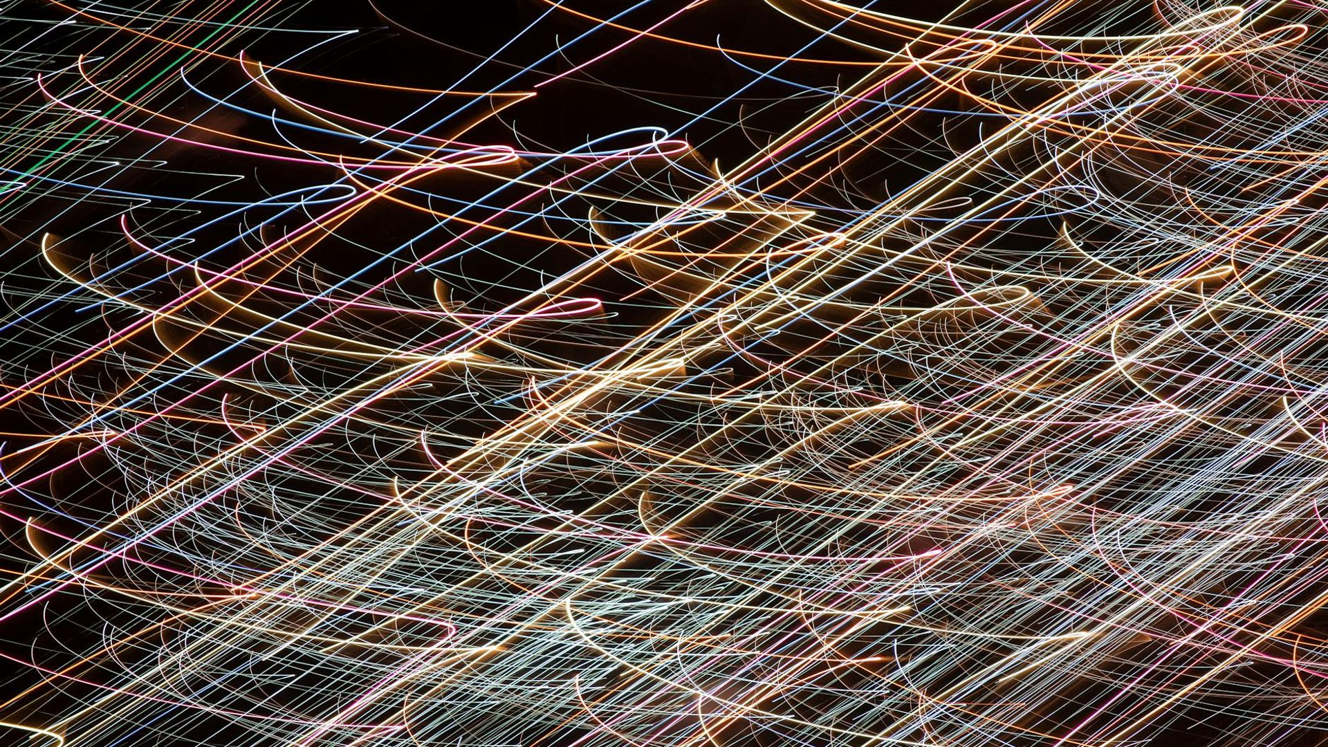 Abstract flowing lines of light on a dark background.