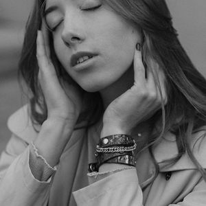 Person meditating with eyes closed in a serene environment.