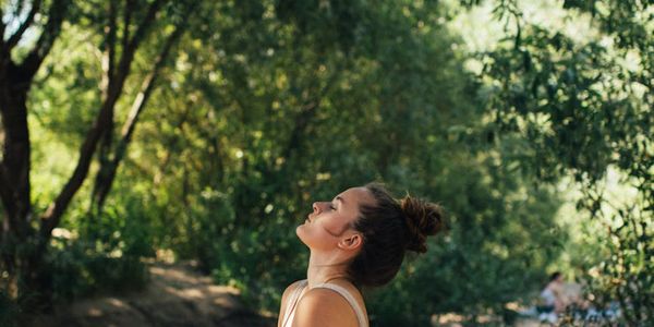 Side view of a person in a deep stretching pose.